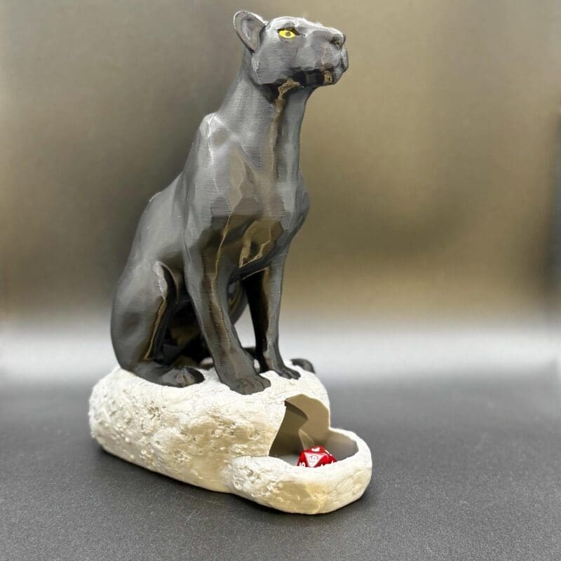 a black panther statue dice tower